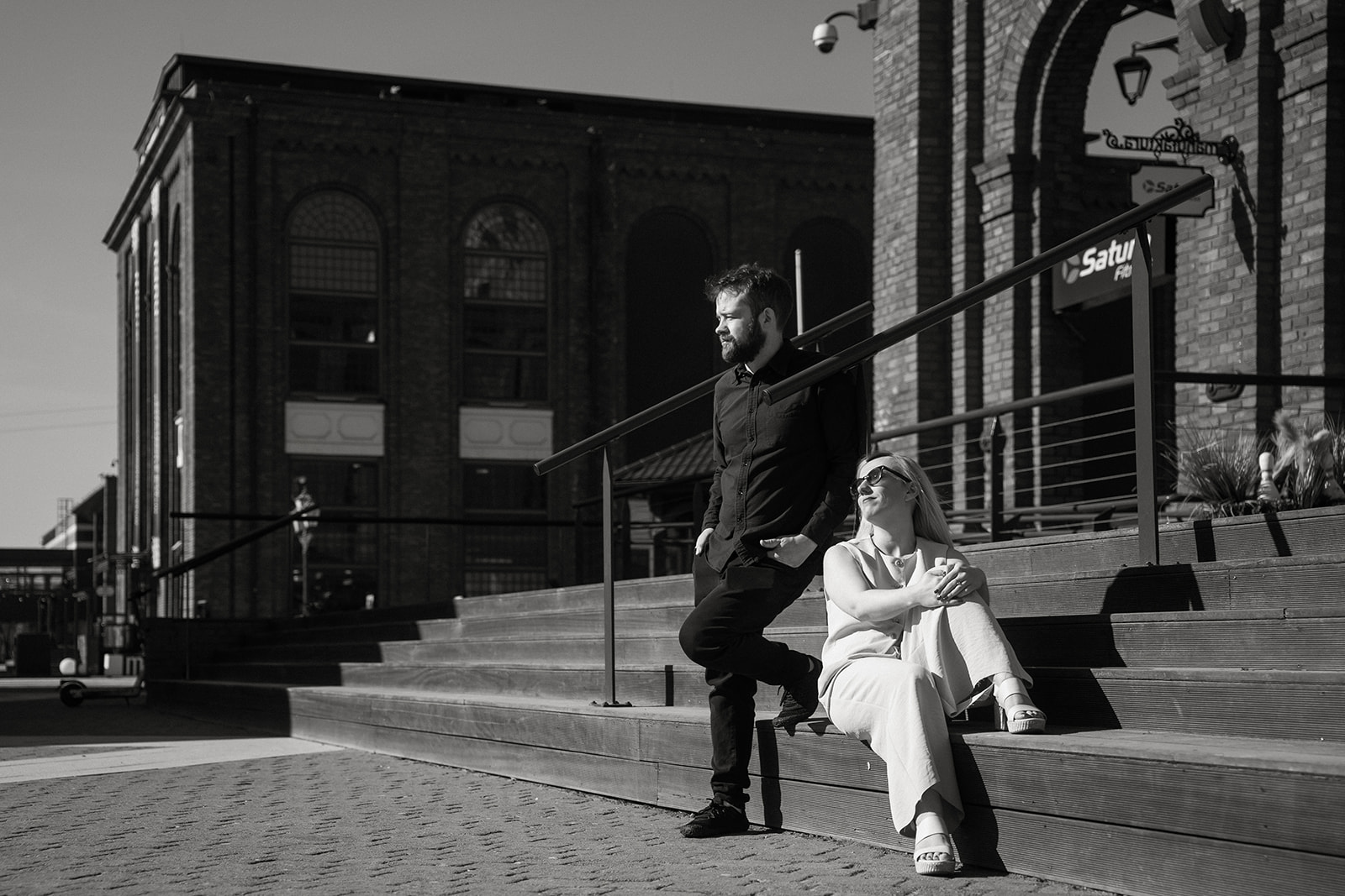 Nat and Alex sitting together on steps